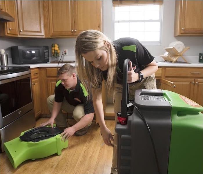 SERVPRO technicians setting up air movers