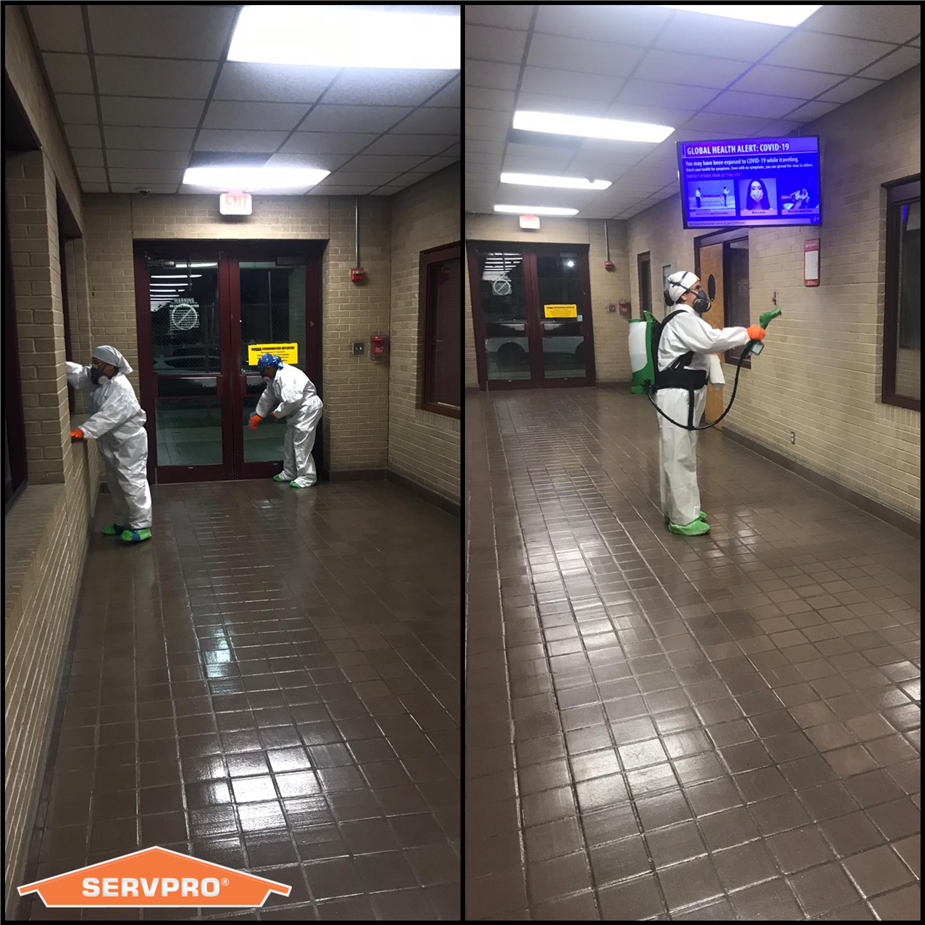 SERVPRO technicians in PPE Suits Cleaning a Business by Spraying and Wiping Down